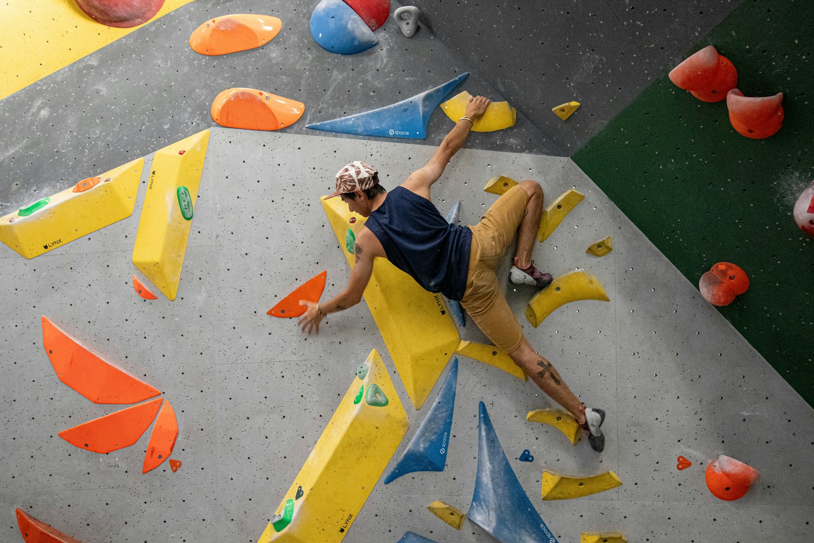 Climber navigating a colorful indoor climbing route