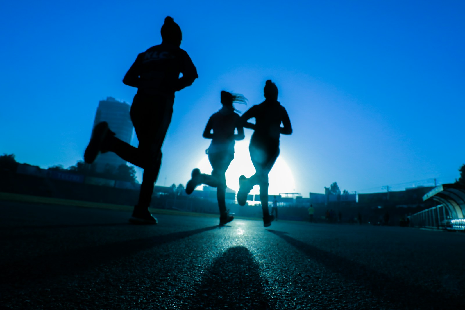 Three runners running together outdoors